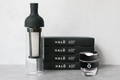 HALÓ coffee brewing system with packaging on a light gray background