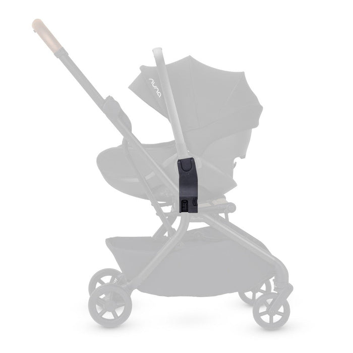 Side profile of a black car seat adapter highlighted in full contrast on a faded stroller frame.