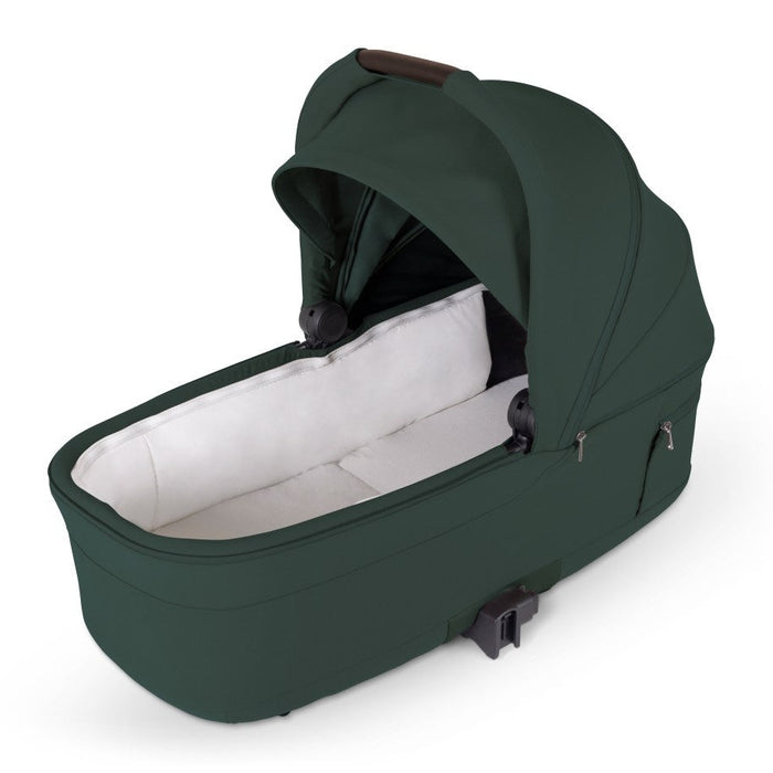 Dark green stroller bassinet with an open canopy and white interior lining.