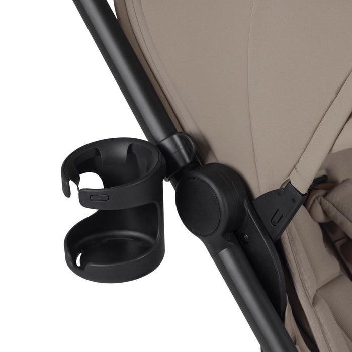 Black plastic cup holder attached to the side of a stroller frame.