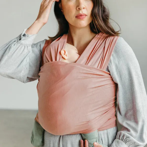 Woman wearing baby in Seasonal Solly Baby Wrap - Rose Quartz